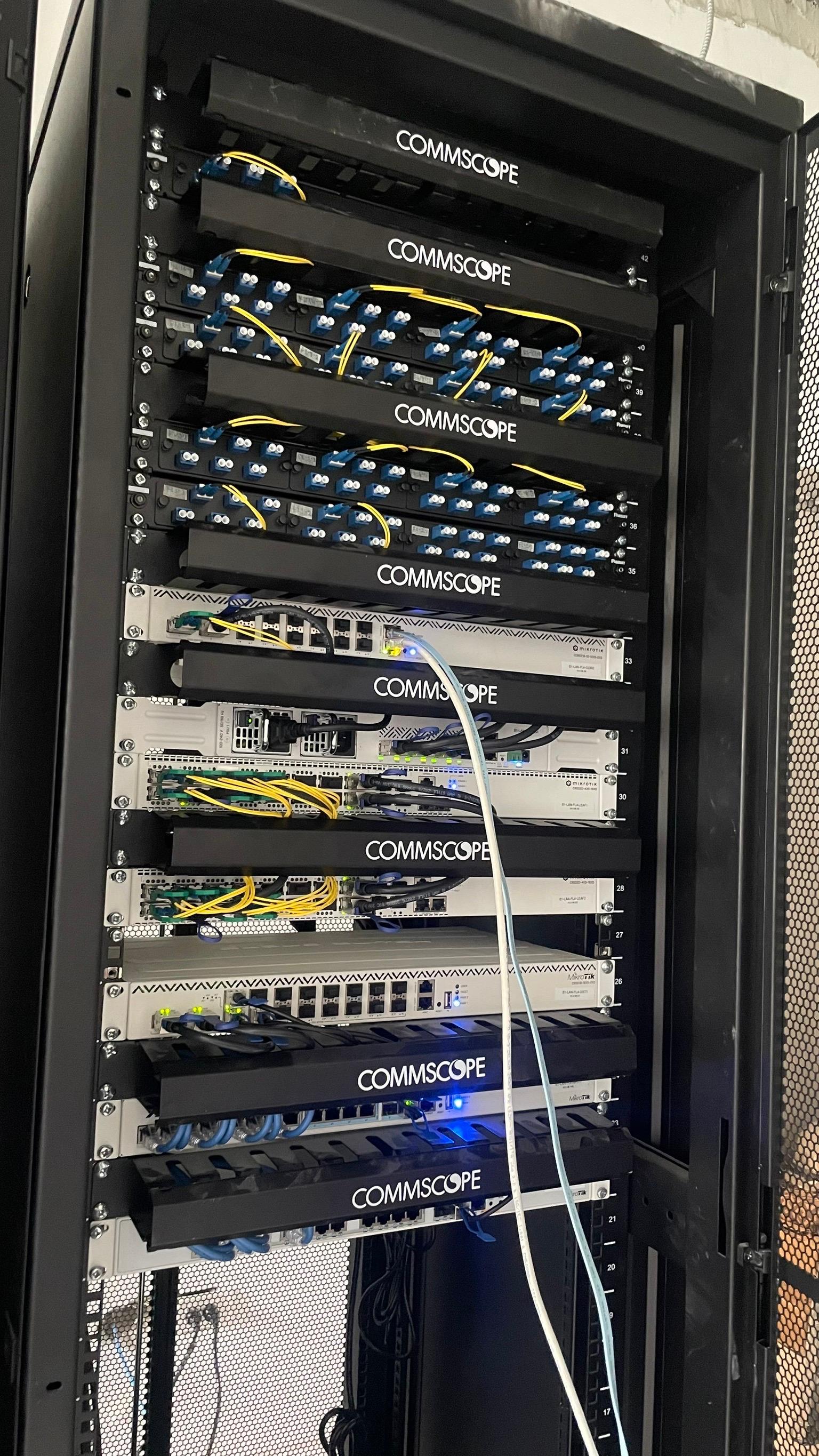 Professional server rack deployment with MikroTik switches and structured cabling